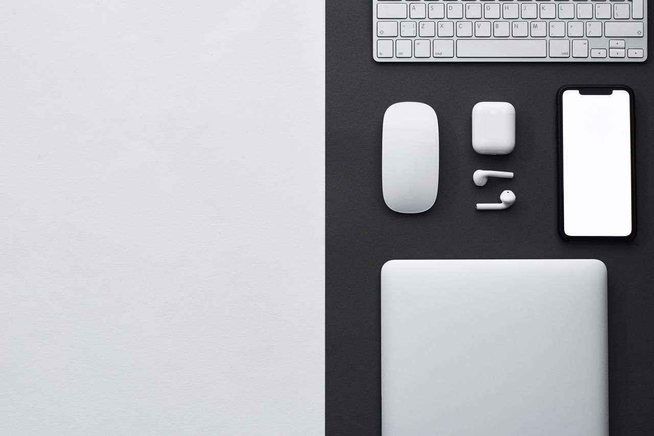 Top view of a sleek workspace featuring modern wireless technology devices.